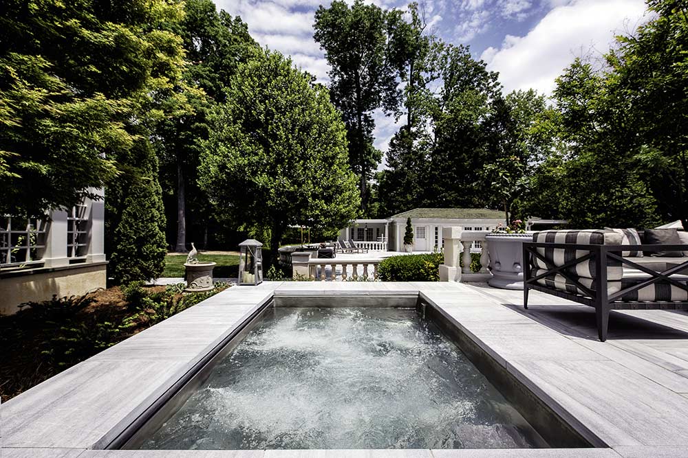 Stainless steel spa with bench seating, LED lighting and auto cover.  96”x106”x46”