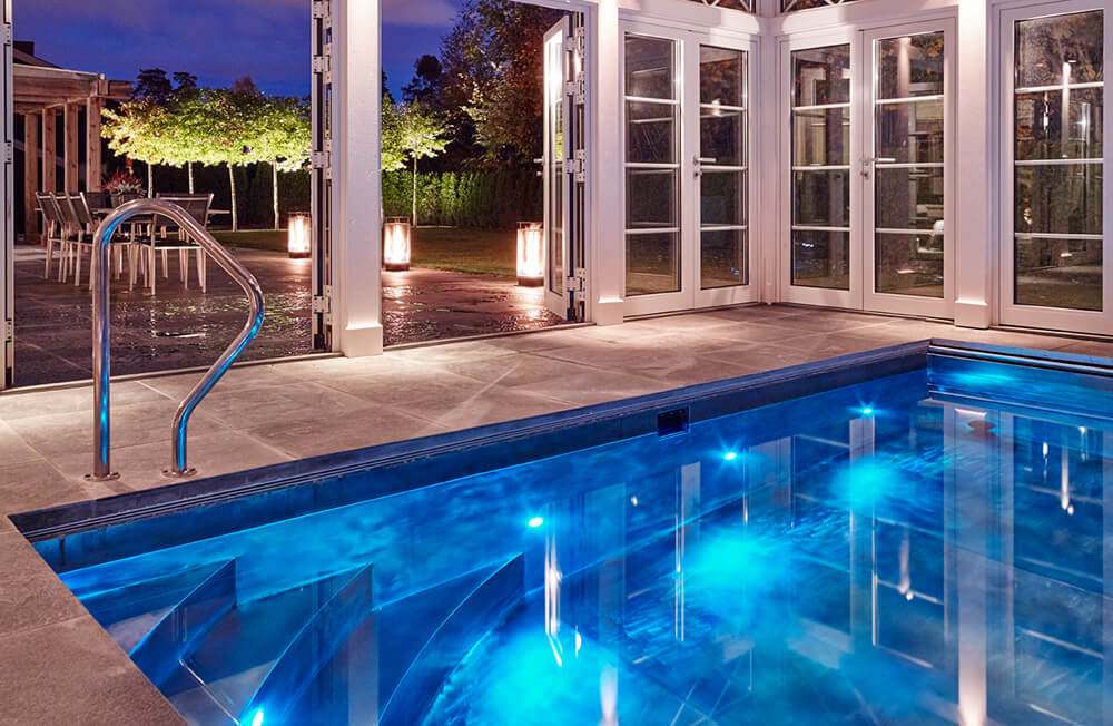 Custom Stainless steel swim spa with interior descending stairway, LED lighting and automatic cover 134” x 253” x 58”