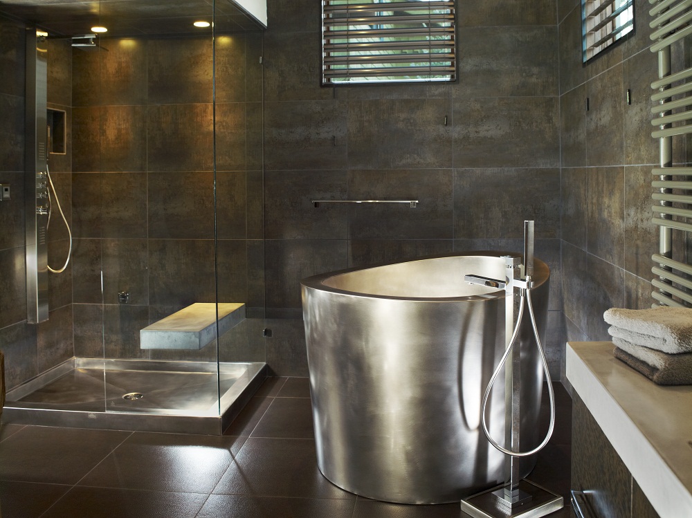 Stainless Steel Japanese Soaking Tub with Matching Stainless Steel Shower Pan in Background Bath Dimensions: 42