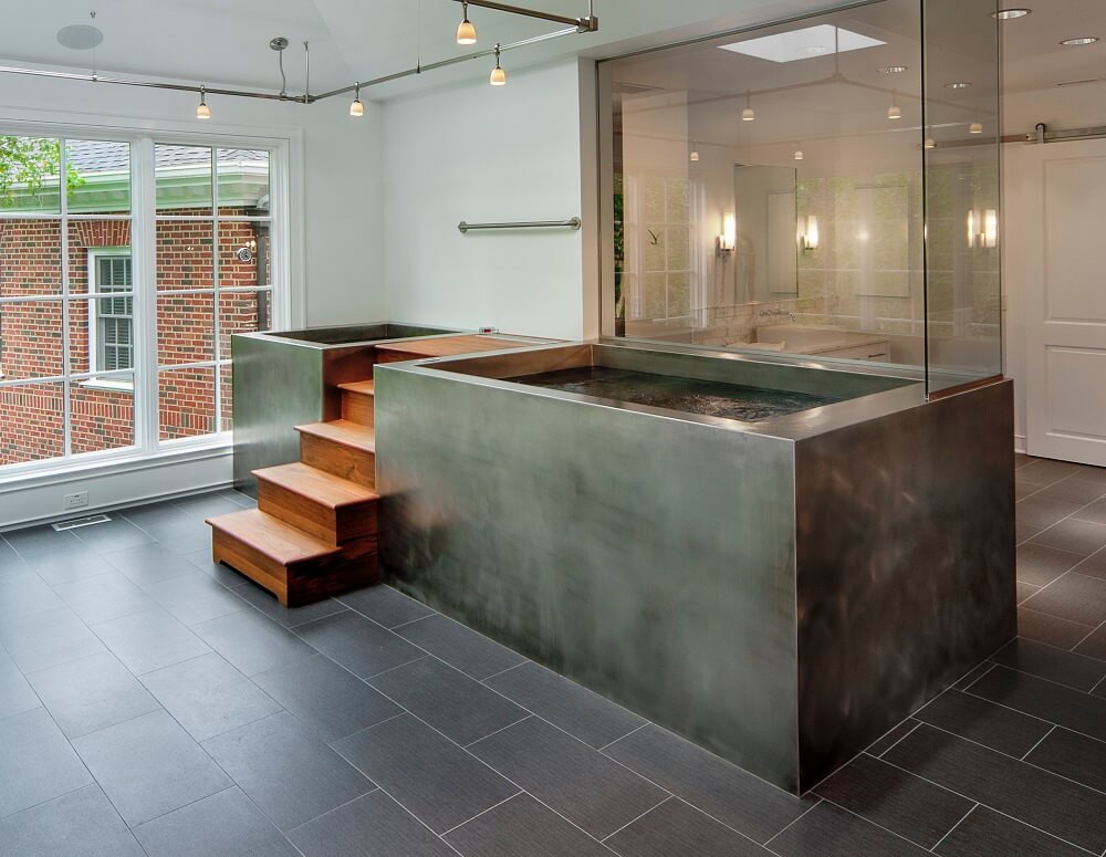 Stainless cold plunge therapy pool and neighboring spa. 