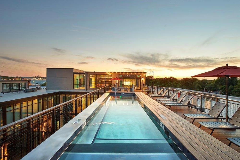 Stainless steel pool with interior descending stairway, LED lighting, lounge and bench seating. 117