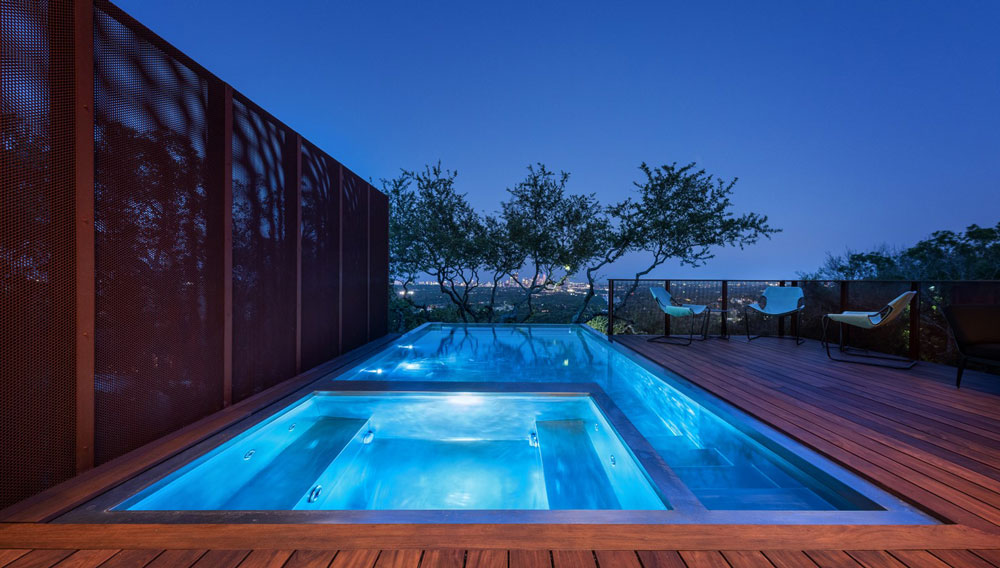 Stainless steel pool and spa combo with descending stairway.  Pool has  glass wall at end and cantilevers out over mountain side below.  137”x280”x55”   