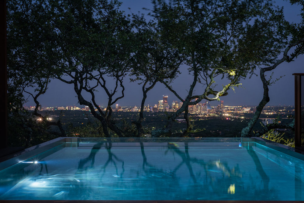  Stainless steel pool and spa combo with descending stairway.  Pool has  glass wall at end and cantilevers out over mountain side below.  137”x280”x55”