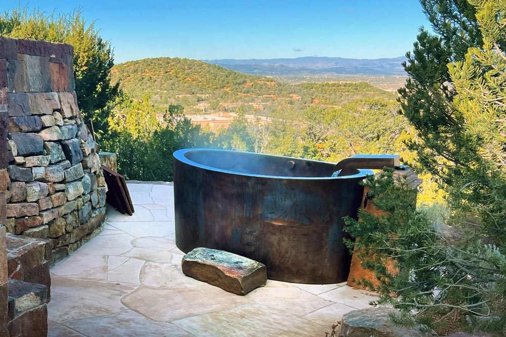 Custom copper Japanese soaking bath with seating for two on the back wall of the bath to allow for hill side viewing.  Custom copper filler also made by Diamond Spas.  48”x72”x35”  