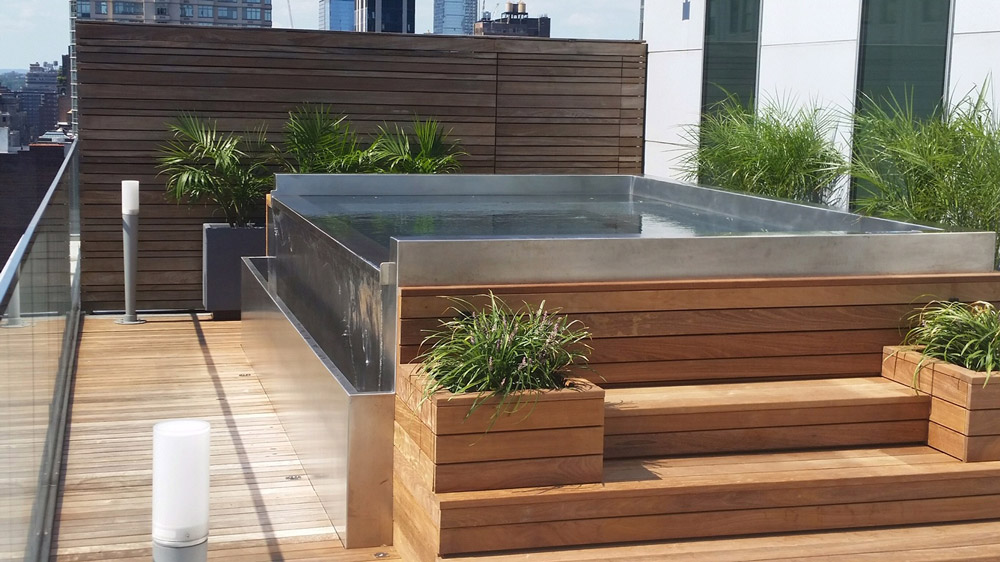Rooftop stainless steel spa with multiple depth seating, LED lighting and front spill over water feature.  94”x147”x42”