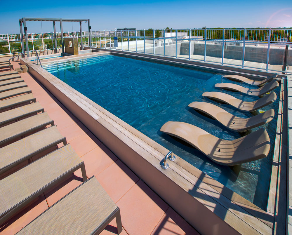 Stainless steel pool with sun shelf, interior stairway, bench seating along pool walls and LED lighting. 244”x631”x59”  Far end of pool are two stainless steel spas with bench seating, interior stairway, and LED lighting.  84”x84”x42”.  Photo courtesy of Union on Elizabeth Street   Photo: Mark Woolcott Photography