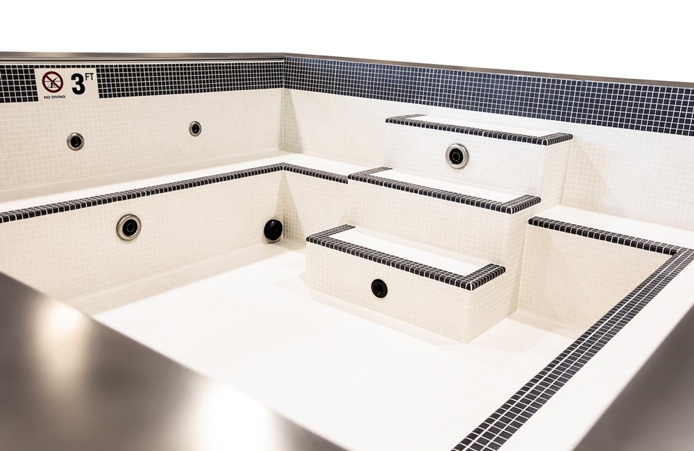 Stainless steel spa with white and black tile  157”x155”x46”