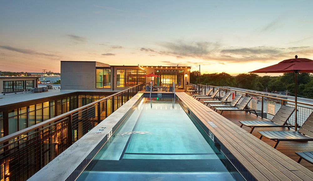 Stainless steel pool with interior descending stairway, LED lighting, lounge and bench seating. 117