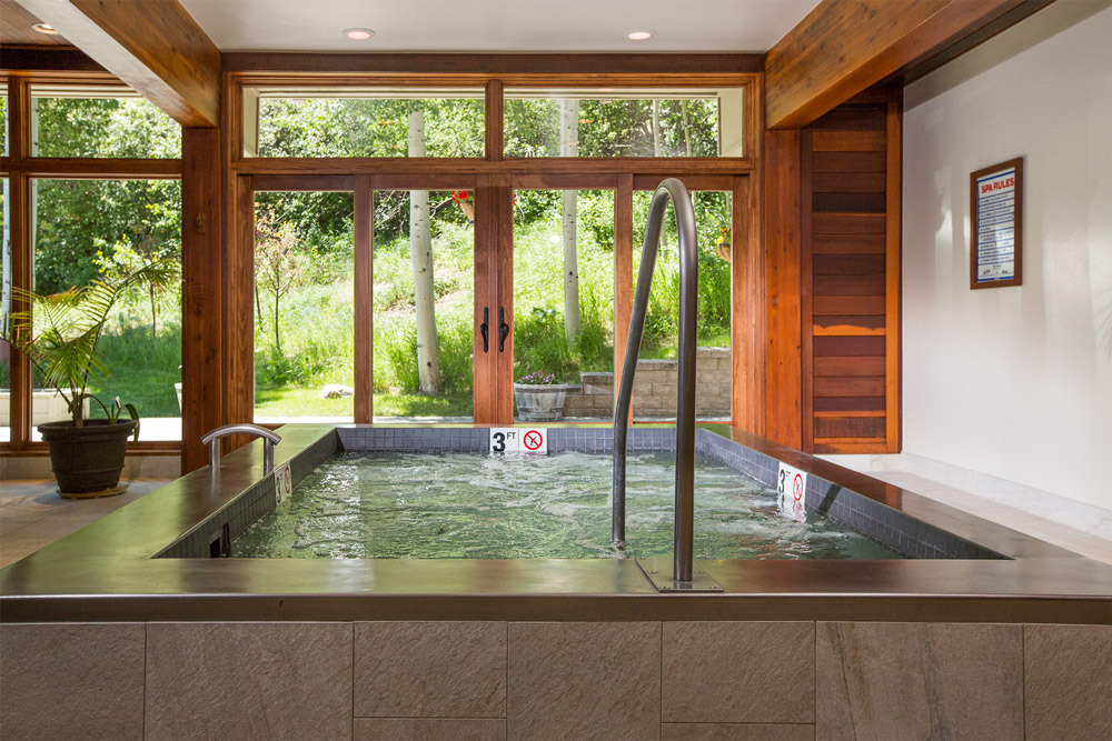 Woods Townhomes, Vail CO. Stainless steel spa with built in bench seating 100” x 82” x 36”.  Tile applied to water line and steps.