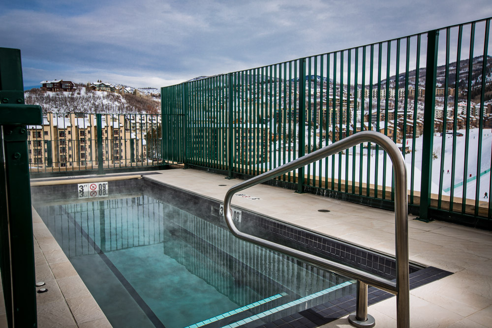 Sheraton Steamboat Resort and Villa.s Rectangular Spa with bench seating and auto cover 84”x216”x42”.  Tile applied to water line and steps.