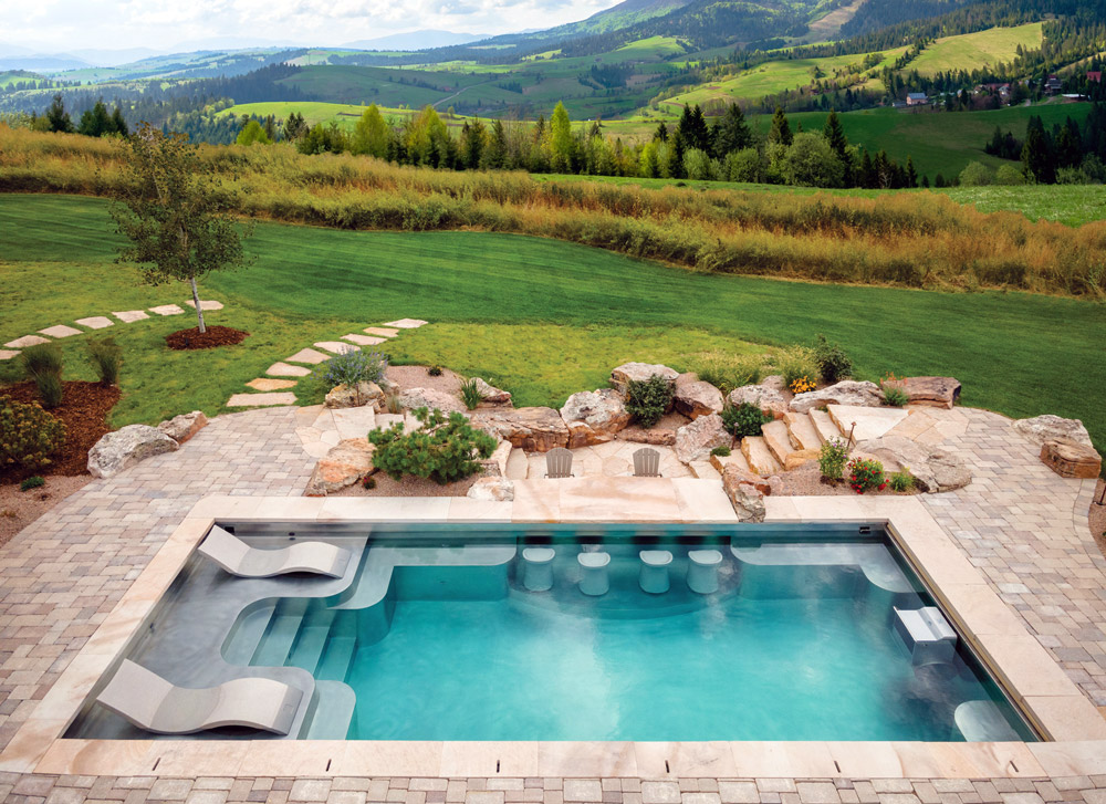 Stainless steel pool with sun shelf, bench seating on side walls of pool, swim up bar, swim spa, laminar jets, and automatic cover.  193”x402”x69”