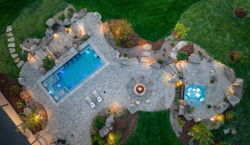 Ariel view of image above with neighboring stainless-steel pool and fire pit.