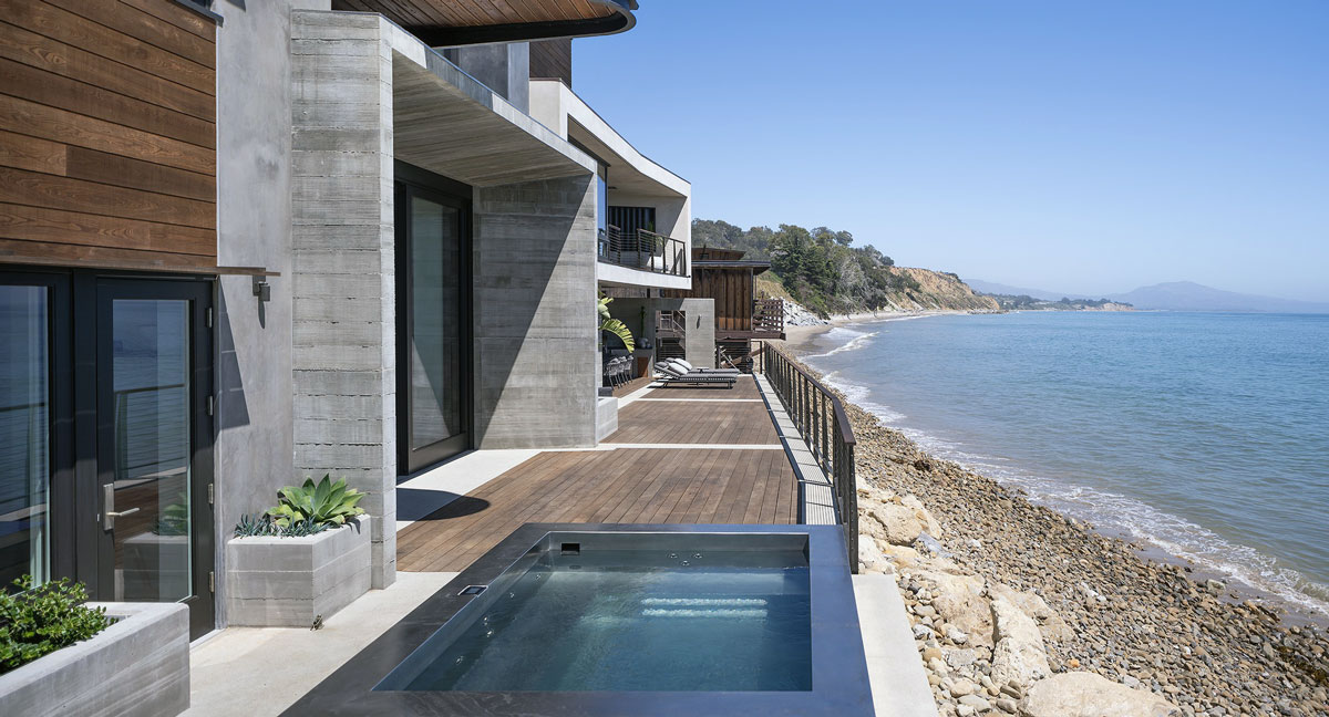 Custom stainless steel spa with bench seating on three sides and front skirting.  136”x92”x42”.